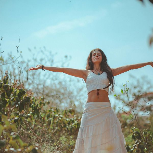 Person meditating peacefully, radiating an aura of calm and well-being.